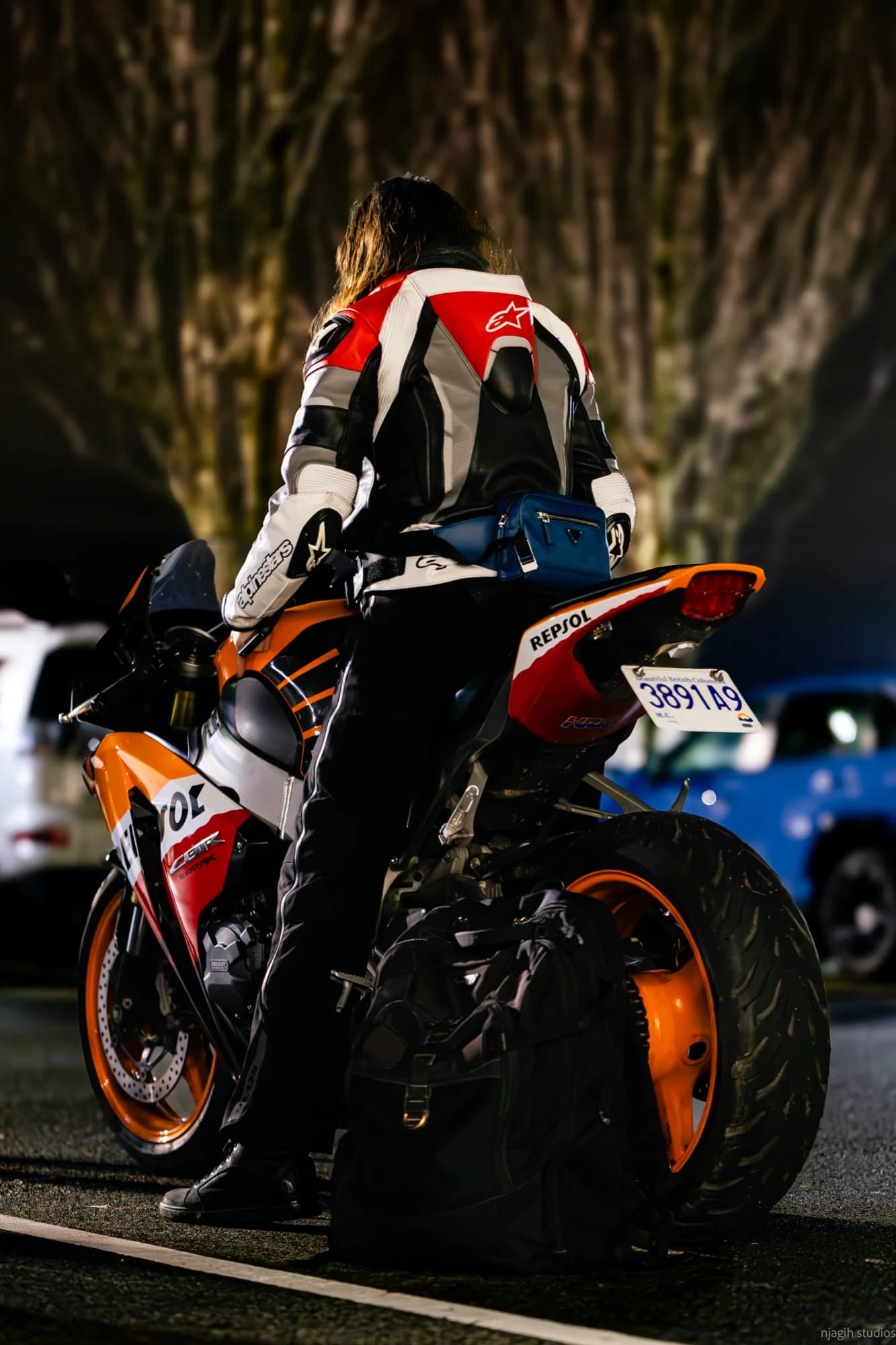 Rider in Alpinestars leather suit on Repsol Honda CBR at Vancouver night ride - Njagih Studios