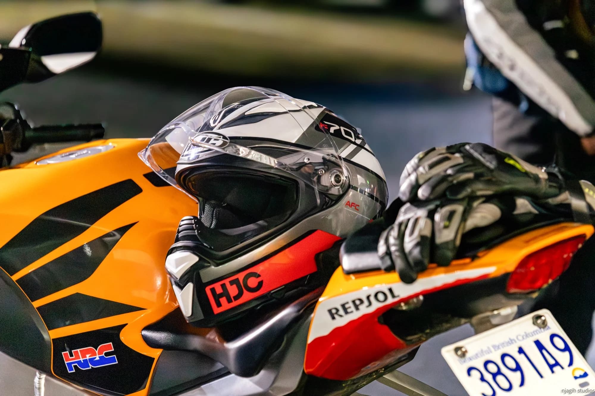 HJC helmet and riding gloves on Repsol Honda HRC motorcycle closeup - Njagih Studios Vancouver