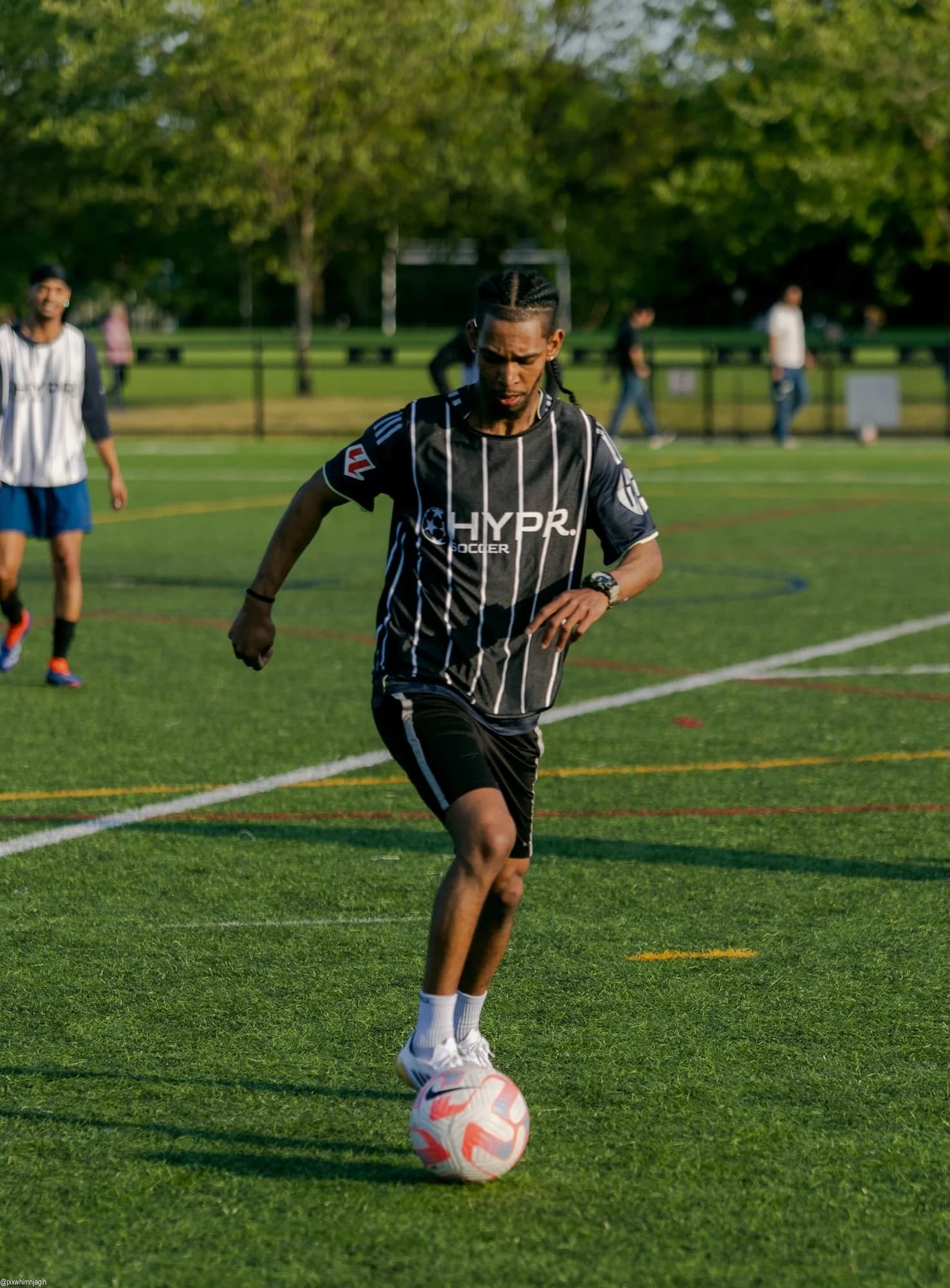 HYPR Soccer player sprinting with the ball during competitive match - Njagih Studios sports photography Vancouver