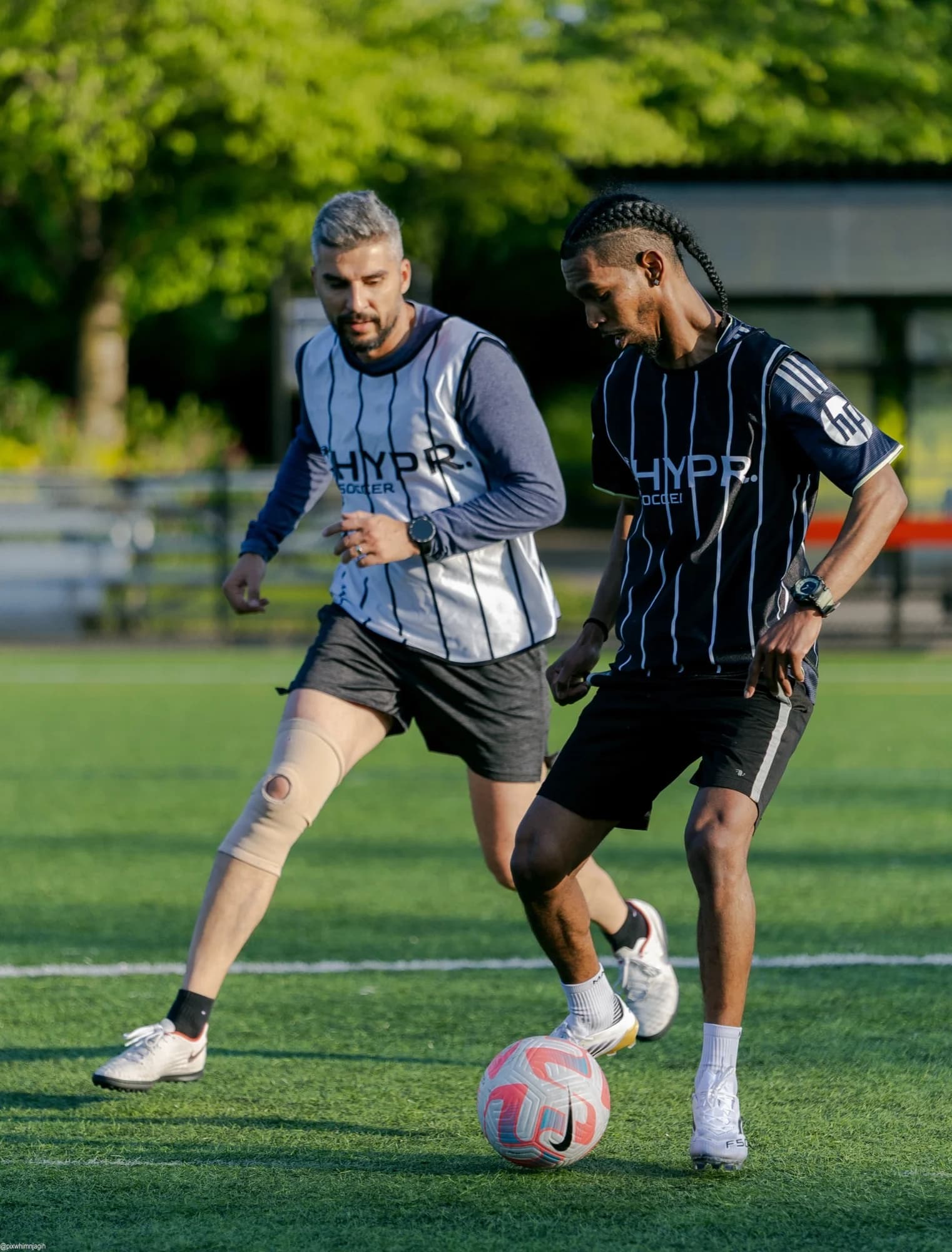 HYPR Soccer players competing for the ball on Vancouver turf field - Njagih Studios sports photography