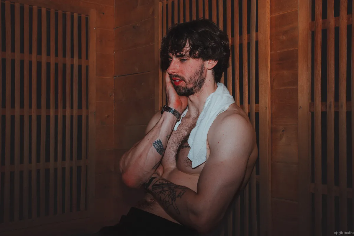Man relaxing in sauna with towel draped over shoulder - Njagih Studios wellness portrait photography