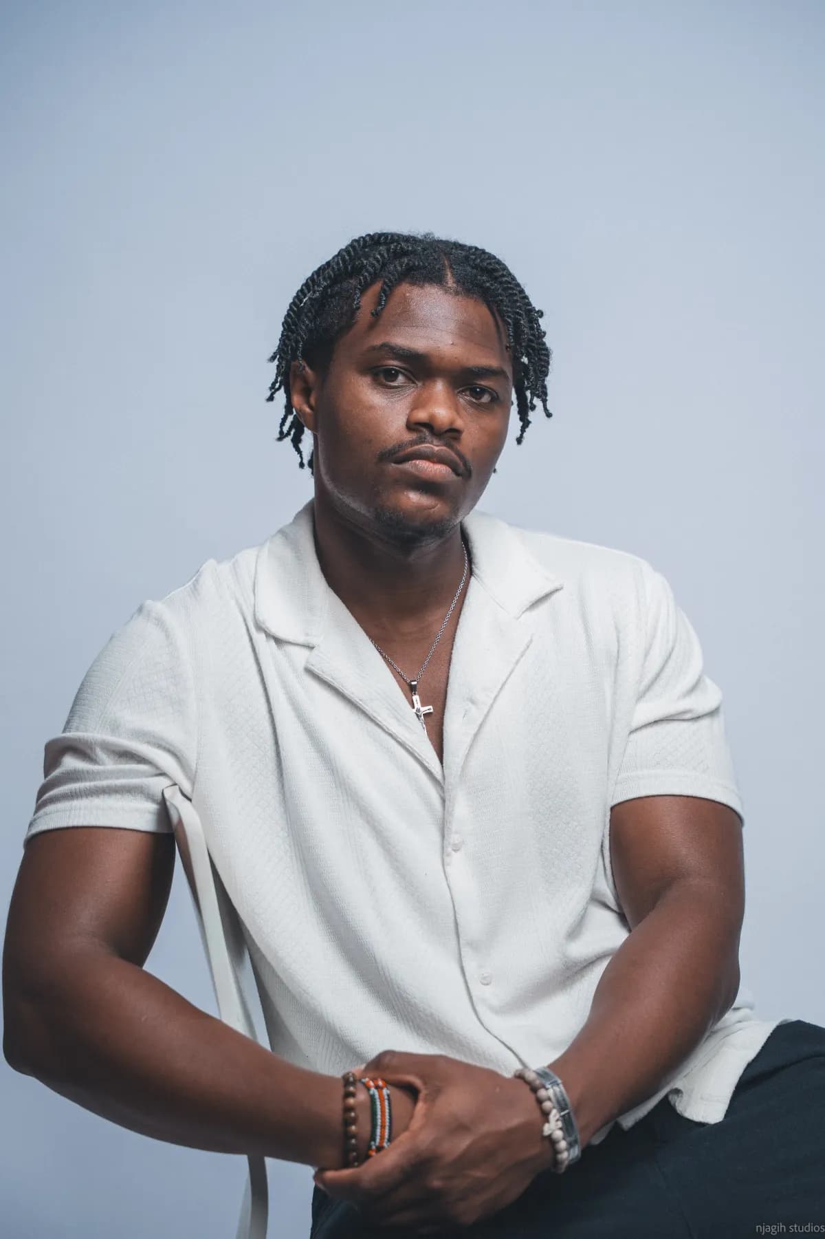 Man in white shirt seated for studio portrait session - Njagih Studios Vancouver photography portfolio