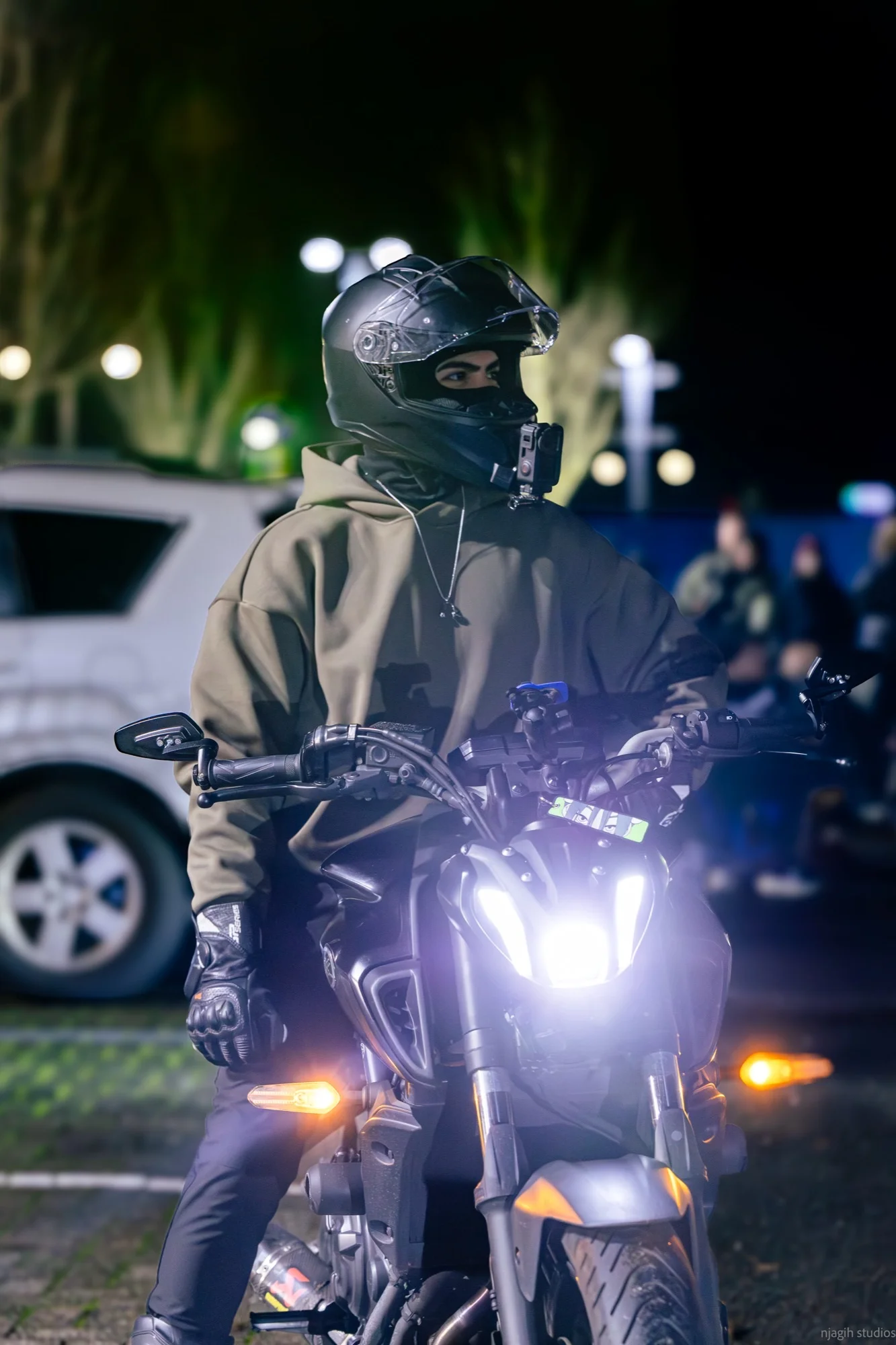 Motorcycle rider with glowing headlight at Vancouver night ride event - Njagih Studios event photography