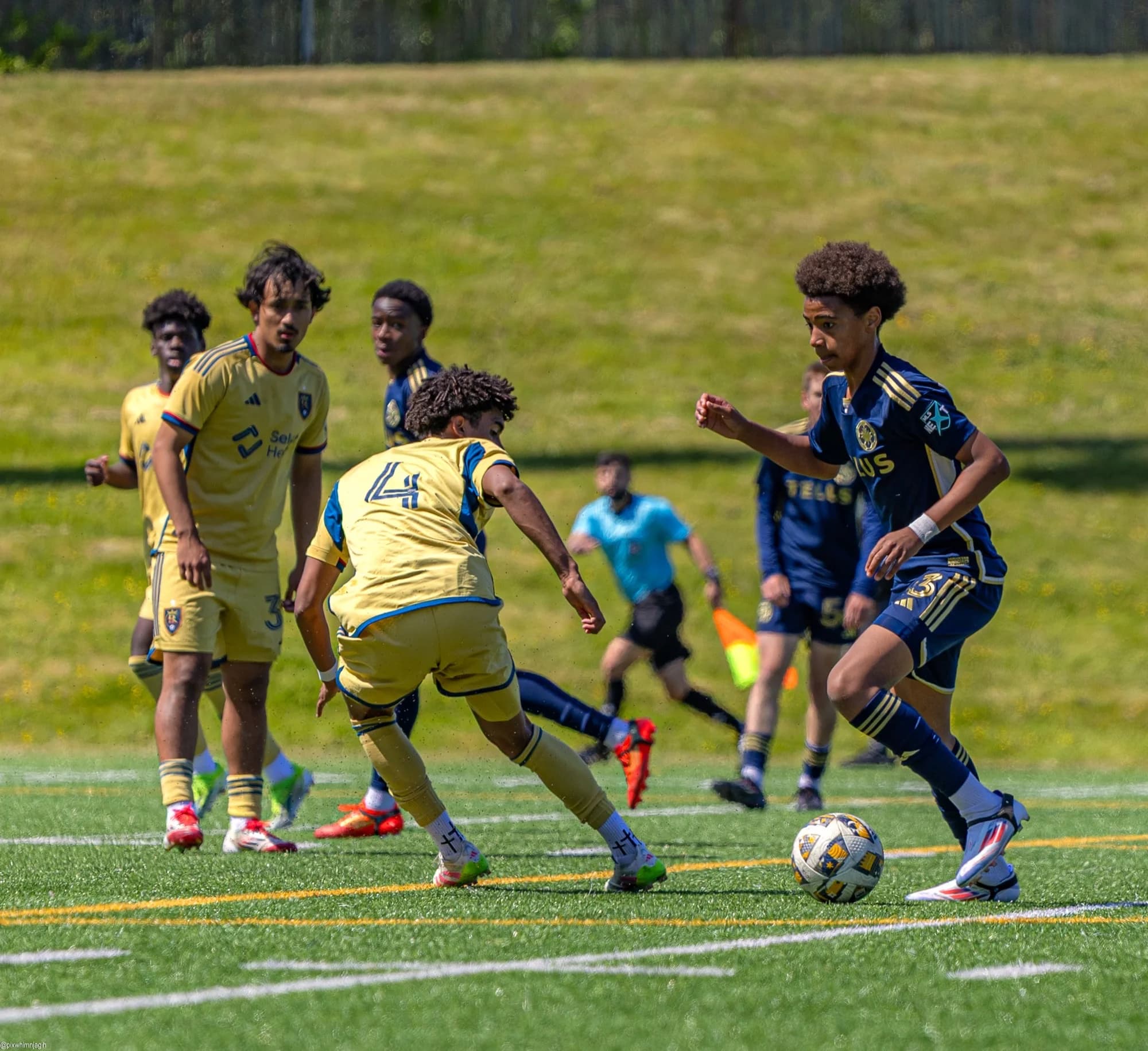 Youth academy soccer match action with players competing on Vancouver pitch - Njagih Studios sports photography